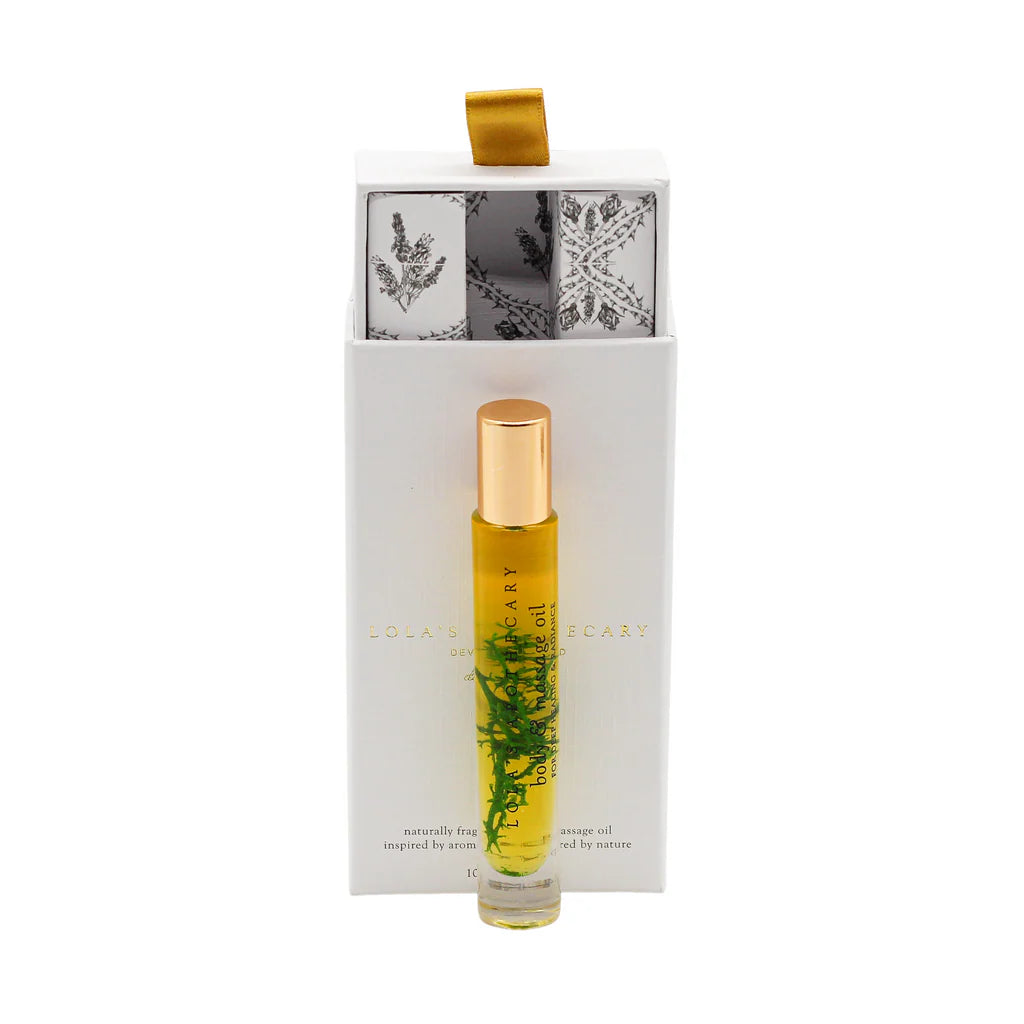 a roll-on bottle of "Breath of Clarity" perfume oil in front of a floral gift box