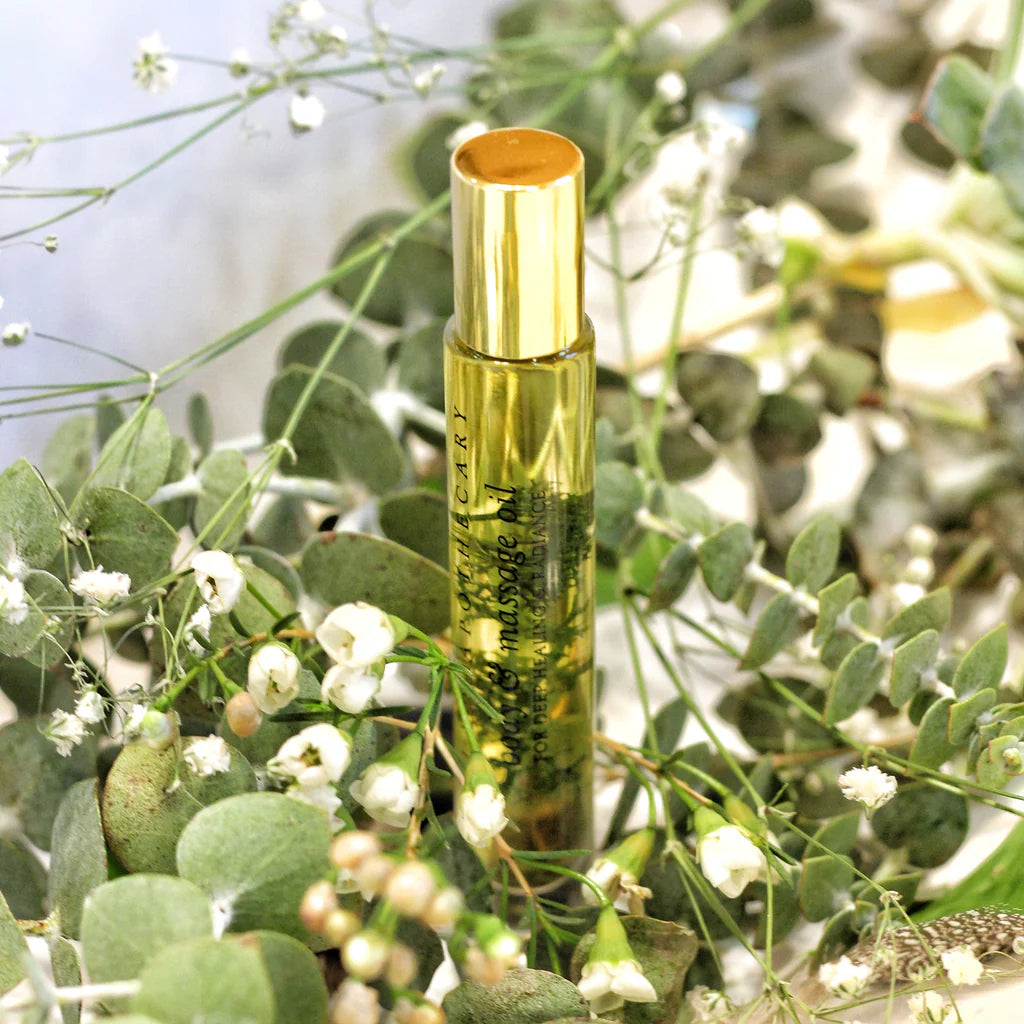 A roll-on bottle of "Breath of Clarity perfume oil with eucalyptus and rosemary leaves