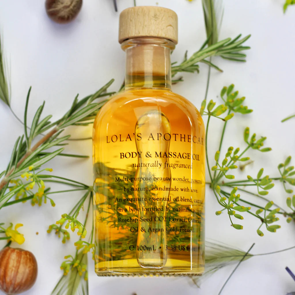 A bottle o "Breath of Clarity" body and massage oil with rosemary leaves