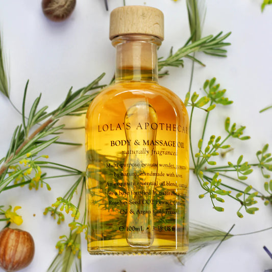 A bottle o "Breath of Clarity" body and massage oil with rosemary leaves