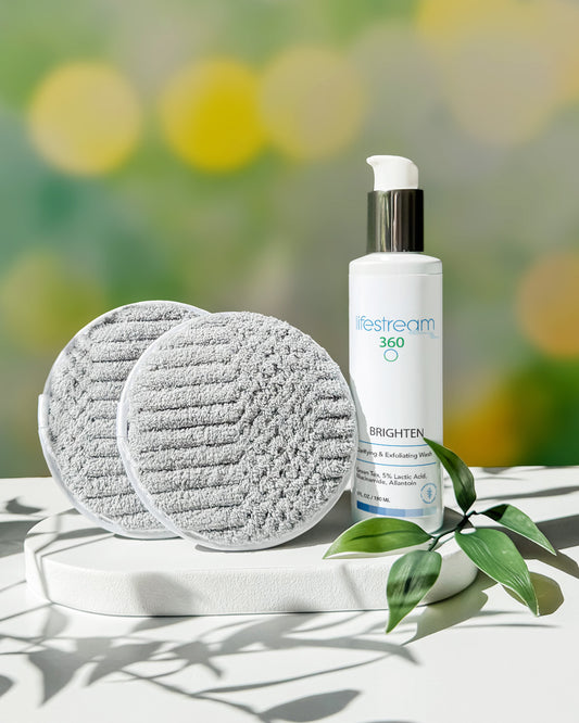 Bottle of Brighten Green Tea Facial Cleanser and gray exfoliating pads