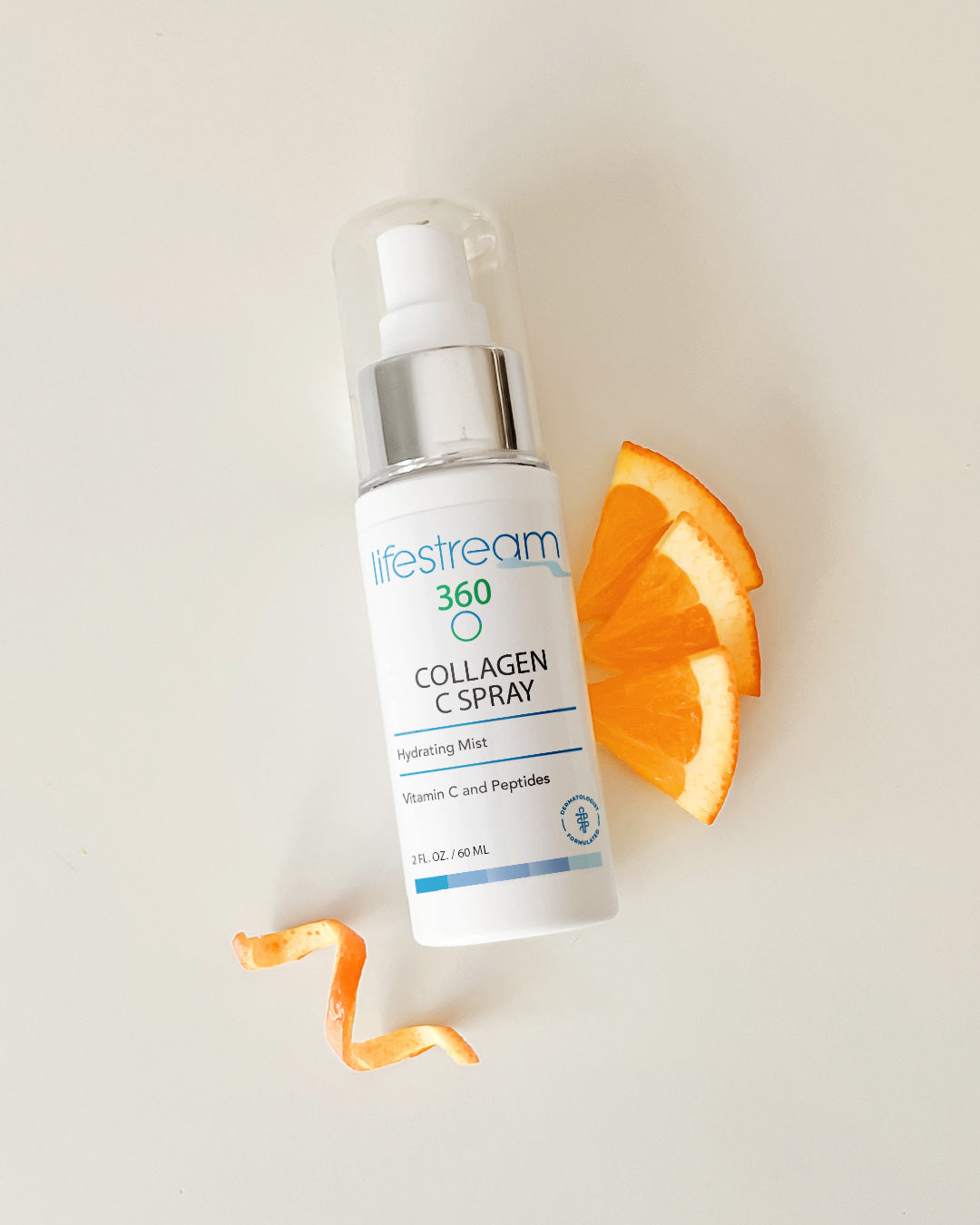Travel size Collagen C Spray bottle with orange slices on a light background