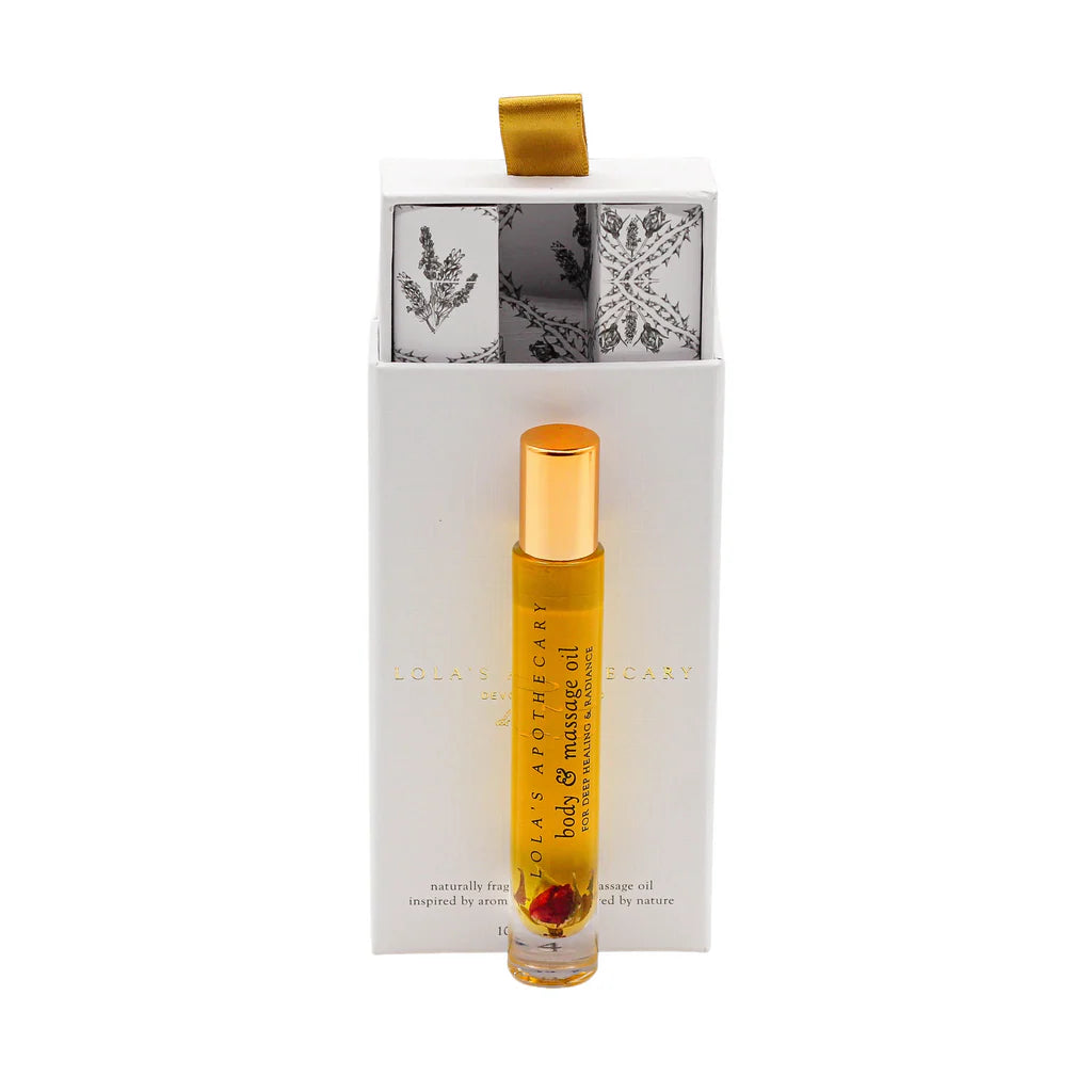  A roll-on bottle of "Divine Grace" perfume oil in front of a floral gift box