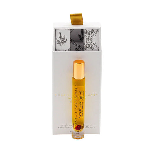  A roll-on bottle of "Divine Grace" perfume oil in front of a floral gift box