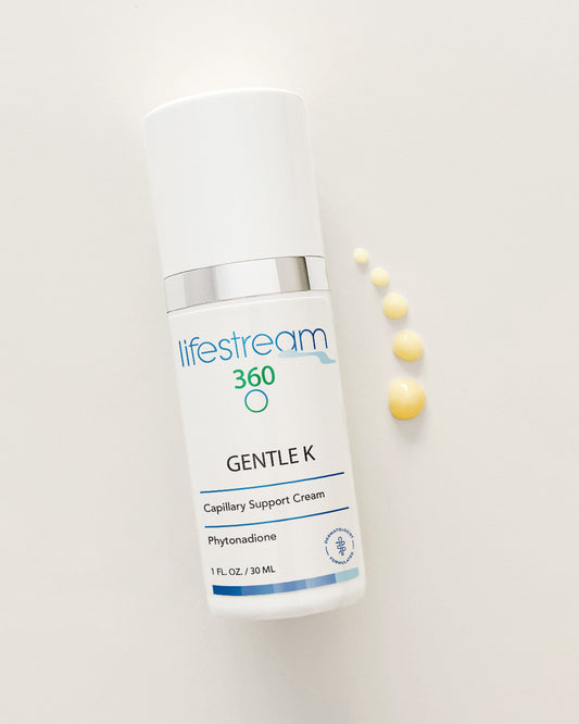 Gentle K face cream moisturizer bottle with yellow droplets on a white background