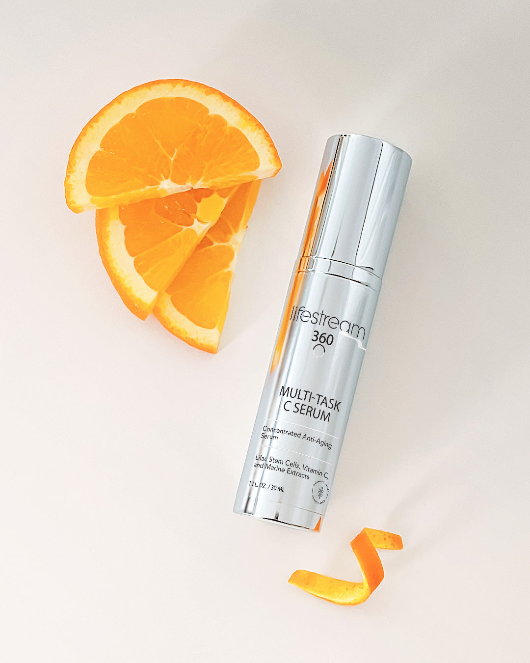 Lifestream 360 Multi-Task C Serum bottle with orange slices on a light background