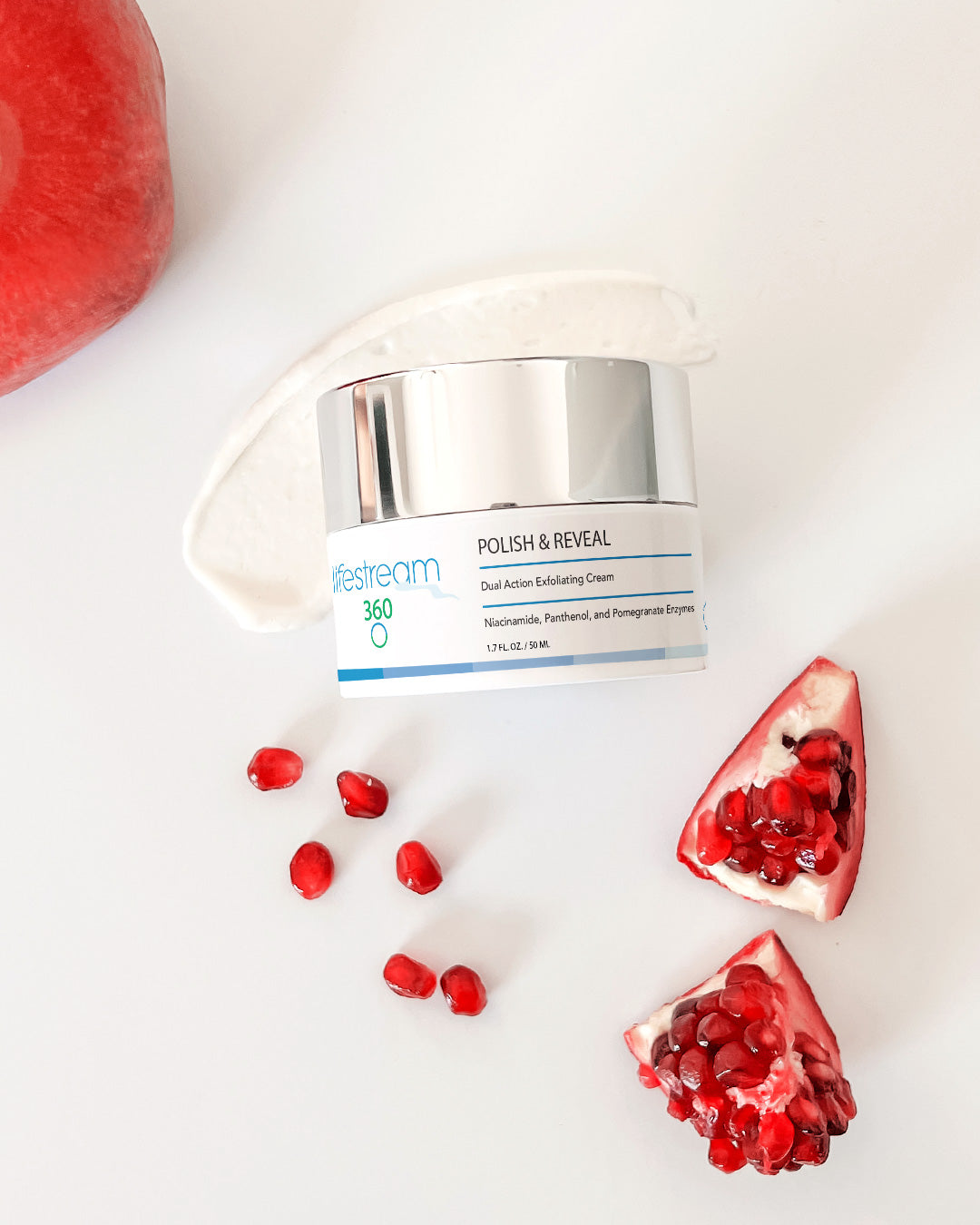 Jar of exfoliating cream "Polish & Reveal" with pomegranate seeds on a white background 