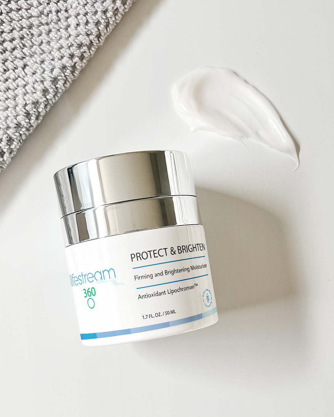 Container of face cream labeled "Protect & Brighten" on a light background