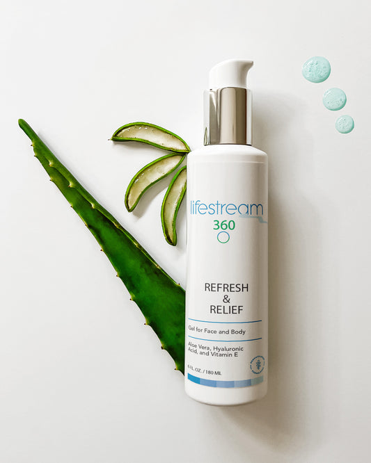 Bottle of aloe vera face gel with aloe leaves on a light background