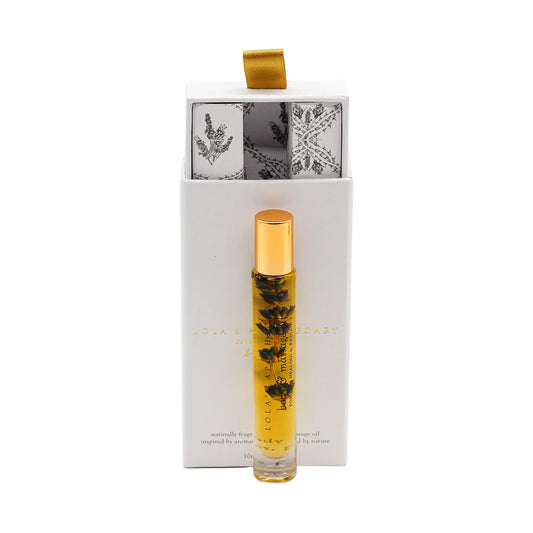 a roll-on bottle of "Sweet Lullaby" perfume oil in front of a floral gift box