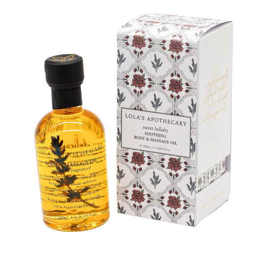 A bottle of "Sweet Lullaby" body massage oil next to floral gift box