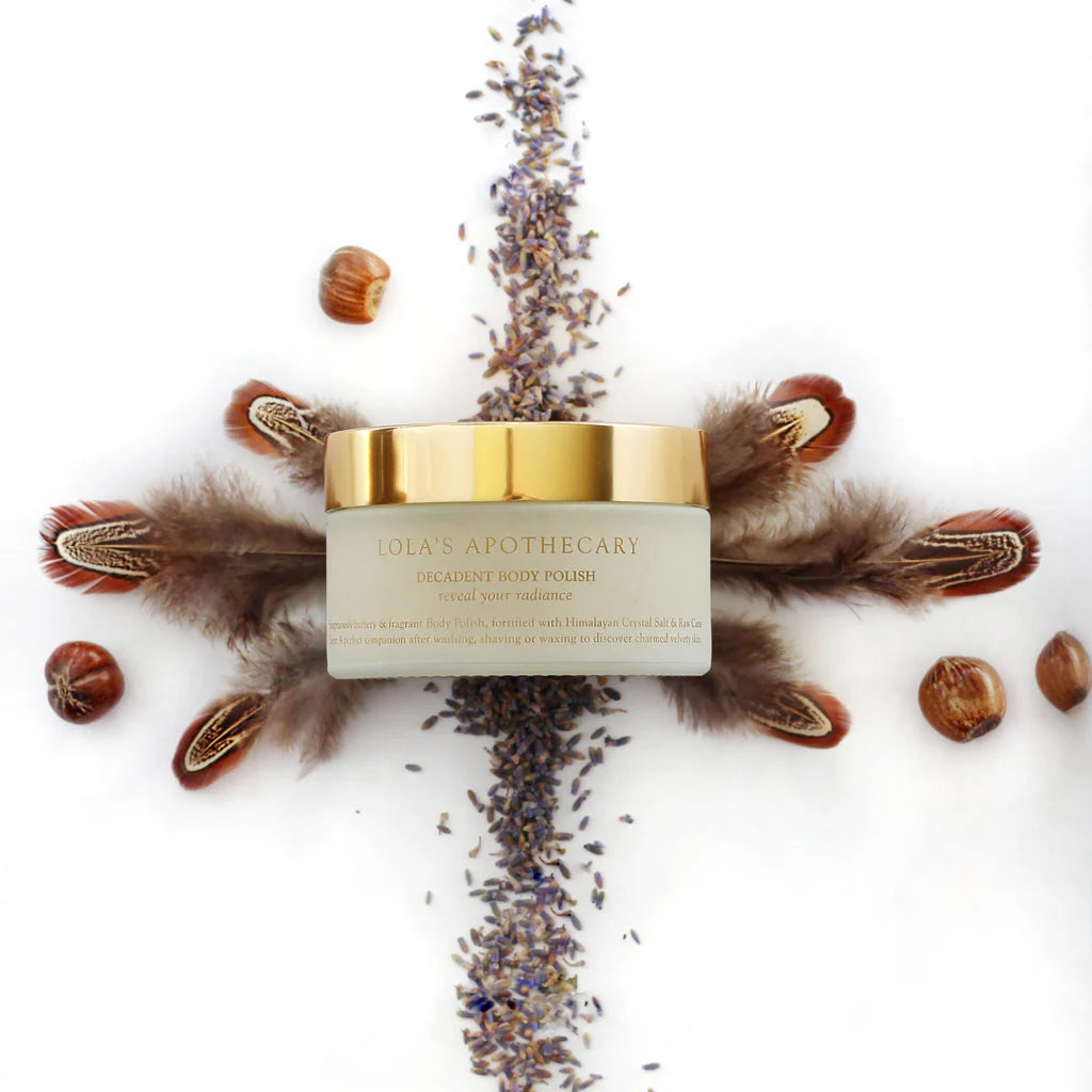 Ajar of Sweet Lullaby body polish scrub surrounded by feathers and lavender 