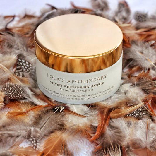 Jar of Sweet Lullaby body souffle moisturizer sitting on fluffy feathers