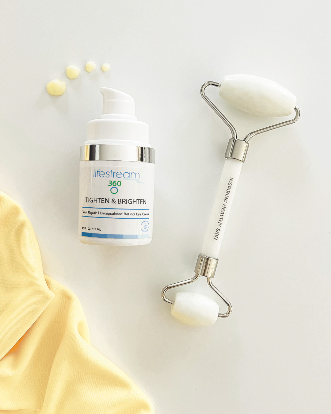 Bottle of Tighten and Brighten  Retinol eye cream and roller on a light background